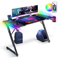 IMHome - Bureau de jeu avec éclairage DEL RVB et tapis de souris gratuit - 47 po x 24 po - Plateau en fibre de carbone noir / structure noire-Cette base haute performance est conçue pour les joueurs qui recherchent une combinaison de style audacieux et de stabilité. Ce véritable centre de commande est doté d’une surface haut de gamme en fibre de carbone, accompagnée d’un système d’éclairage DEL intégré qui transforme votre pièce en un environnement de jeu immersif. Conçu pour optimiser chaque centimètre de 