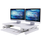 Rocelco 32" Sit To Stand Ergonomic Adjustable Height Desk Riser with Easy Up-Down Handles, White-Easy Height Adjustment with EVR Enhanced Vertical Range: Sturdy metal frame with easy-grip side handles and gas piston assist, can raise and lower up to 35 lbs., with continuous height adjustment from 5" up to 18" above desktop to optimize the ergonomic work position for people of all heights. Straight up and down motion minimizes required depth (21").