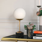 Hudson&Canal Reagan 17.75" Tall Table Lamp with Glass Shade - Brass/ Black Marble/White Milk-Handcrafted brass and black marble finish is applied to the globe marble and metal base