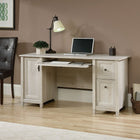Sauder 59"W Edge Water Desk - Chalked Chestnut-Features of this small home office desk include:  Flip-down molding reveals slide-out keyboard/mouse shelf with metal runners and safety stops