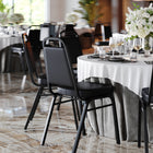 Flash Furniture HERCULES Series Trapezoidal Back Stacking Banquet Chair in Black Vinyl - Black Frame - 4 Pack-500 lb. Weight Capacity