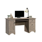 Sauder 59"W La Collection Sauder Select Bureau - Finition Laurel Oak-  L'espace de rangement derrière la porte peut contenir une tour CPU verticale et dispose d'une étagère réglable