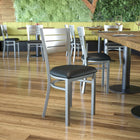 Flash Furniture HERCULES Series Silver Slat Back Metal Restaurant Chair - Black Vinyl Seat-Welded Joint Assembly