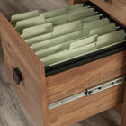 Sauder 66"W Cannery Bridge L-Desk - Sindoori Mango-Cord management system with desktop grommet holes prevents cord clutter